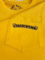 Yellow T-shirt chest pocket with black logo patch