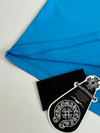 Folded blue T-shirt fabric with side seam stitching and hang tag