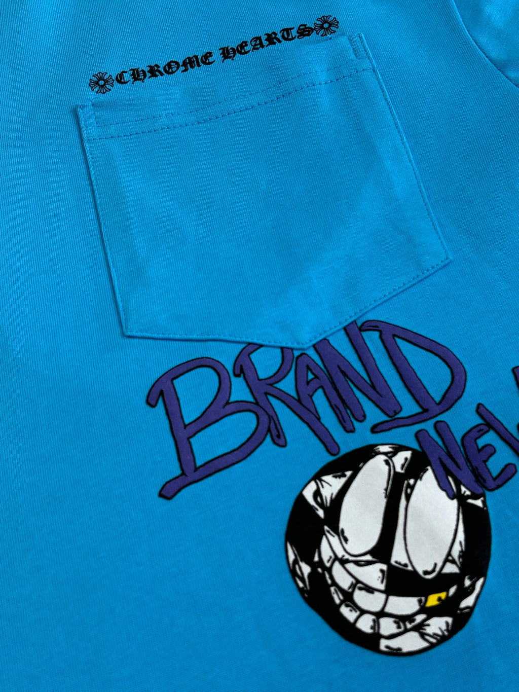 Blue T-shirt front with pocket graphic and large “BRAIN” text print