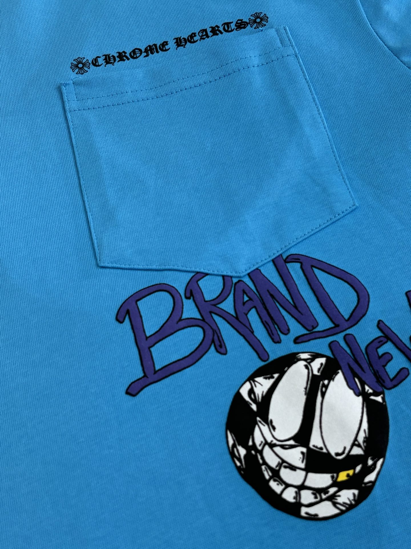 Blue T-shirt front with pocket graphic and large “BRAIN” text print