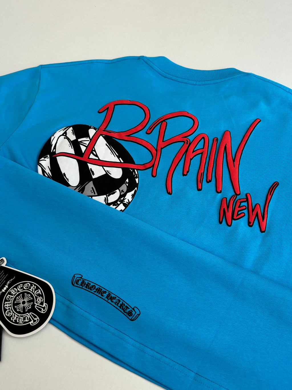 Blue T-shirt sleeve and back print featuring “BRAIN” text