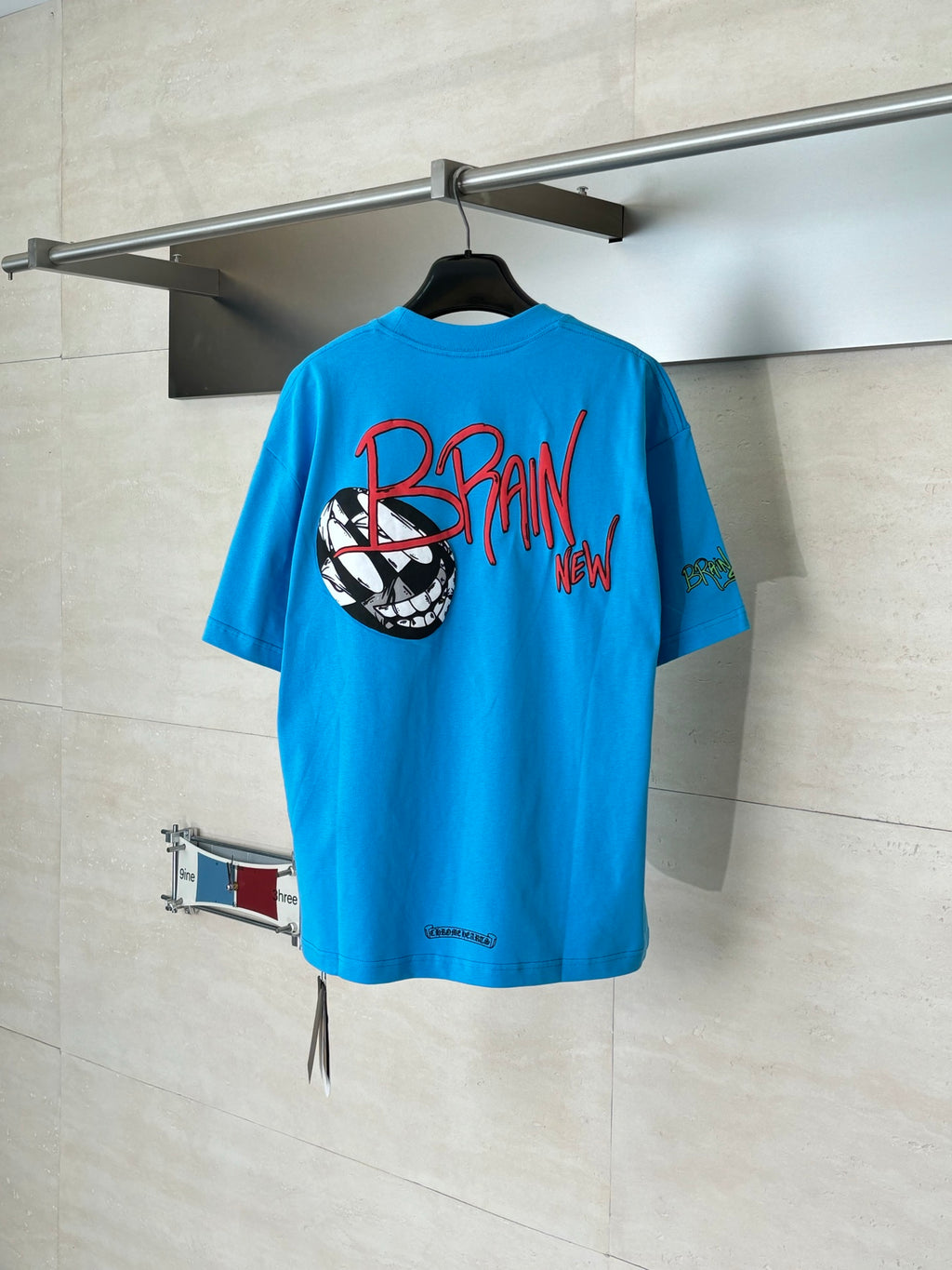 Blue graphic T-shirt with back print featuring a soccer ball graphic and text