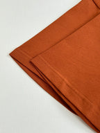 Folded orange short-sleeve T-shirts in a stack