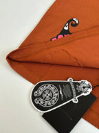 Orange T-shirt folded hem with pink character graphic and hanging hang tag