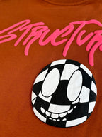 Orange T-shirt close-up with pink StreetLife script and black-and-white face graphic