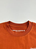 Orange crew-neck T-shirt with printed interior neckline text and Made in USA