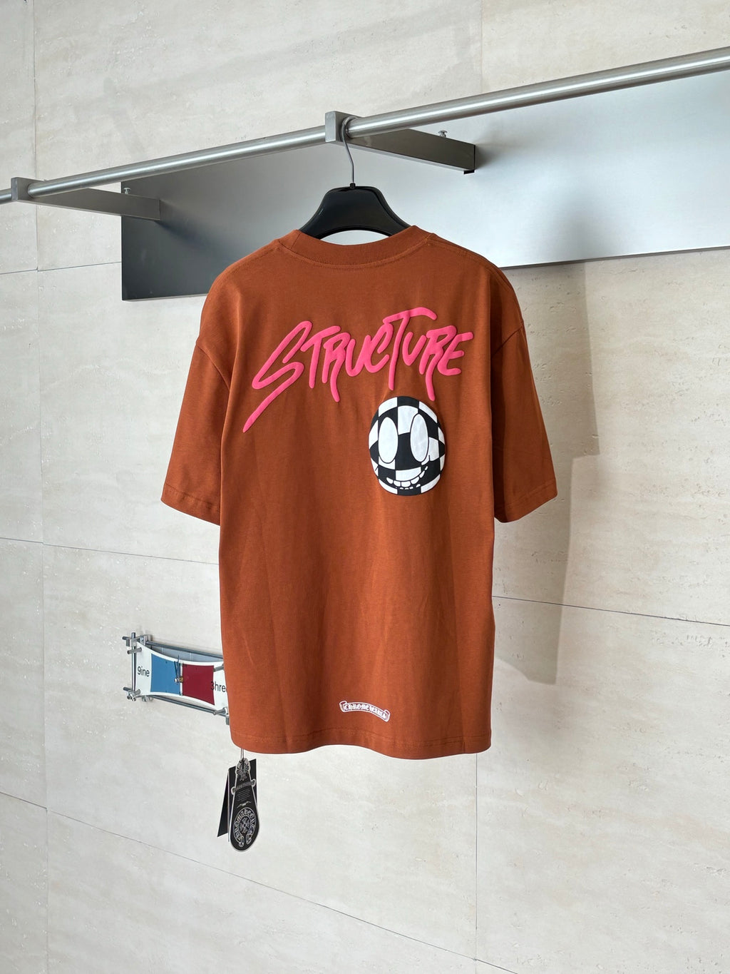 Orange short-sleeve T-shirt back with pink StreetLife text and soccer ball graphic