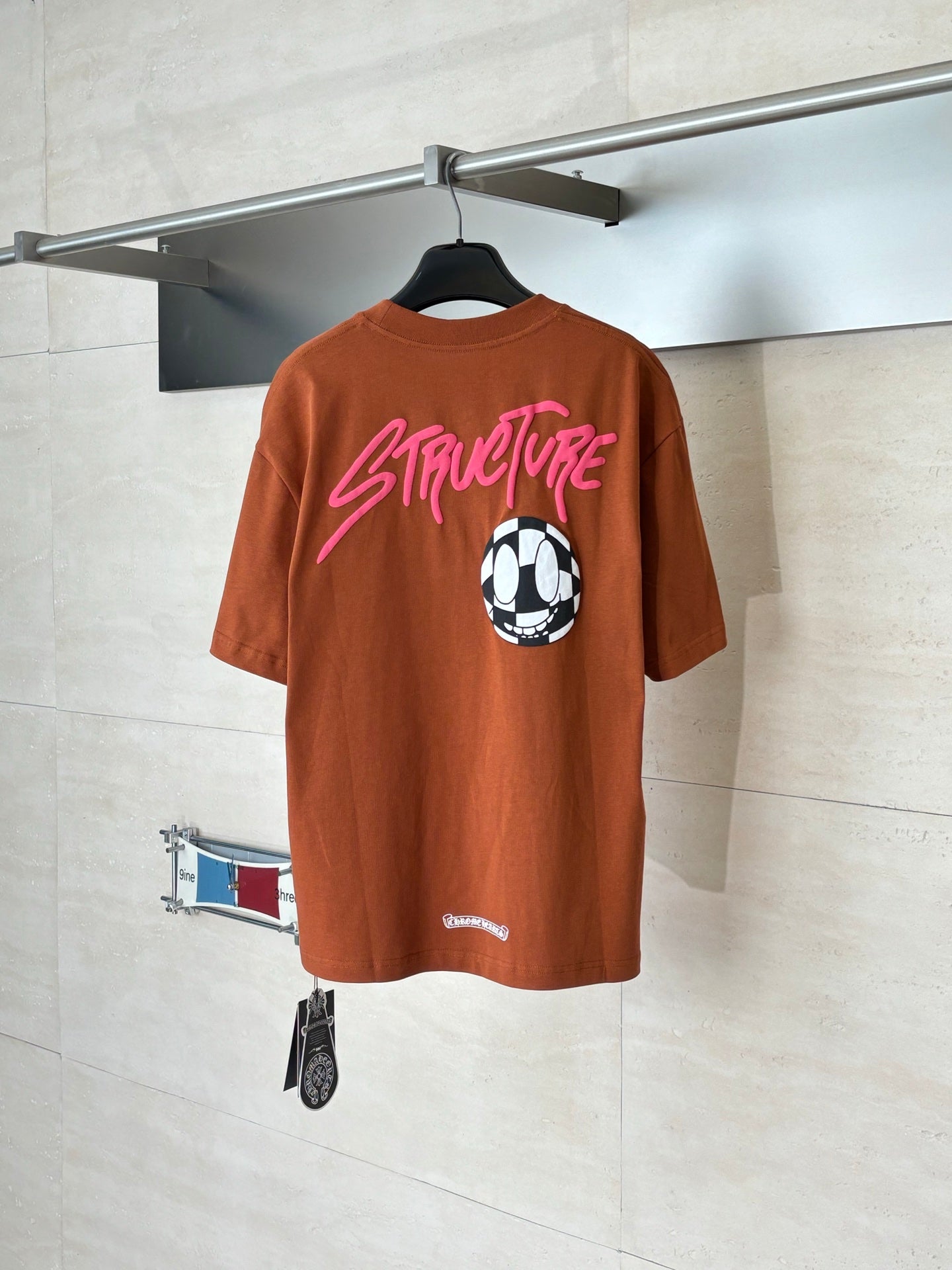 Orange short-sleeve T-shirt back with pink StreetLife text and soccer ball graphic