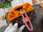Louis Vuitton monogram handbag interior with orange lining and pink strap lanyards