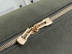 Louis Vuitton gold zipper pull on olive green suede with stitched zipper edge