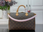Louis Vuitton monogram handbag with tan handles and pink-trimmed front opening