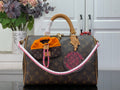 Louis Vuitton monogram handbag with tan handles and pink-trimmed top edge