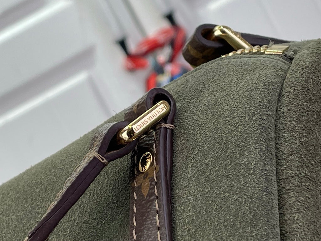 Louis Vuitton logo hardware tag on olive green bag edge with brown monogram strap
