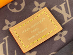 Louis Vuitton leather label patch with yellow stitching on monogram handbag