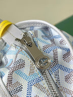 Top zipper area of light blue monogram bag with metal pull and zipper teeth