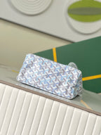 Folded view of light blue monogram clutch-style bag with top flap and handle
