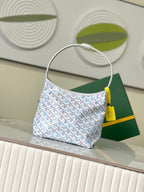 Light blue monogram hobo shoulder bag with rounded top handle and yellow pull tab