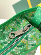Green patterned bag zipper with silver logo pull and metal zipper teeth.