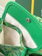 Green patterned mini bag with interior panel, snap button, and stitched trim.