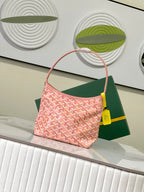 Goyard pink patterned tote bag with curved handles and yellow charm tag