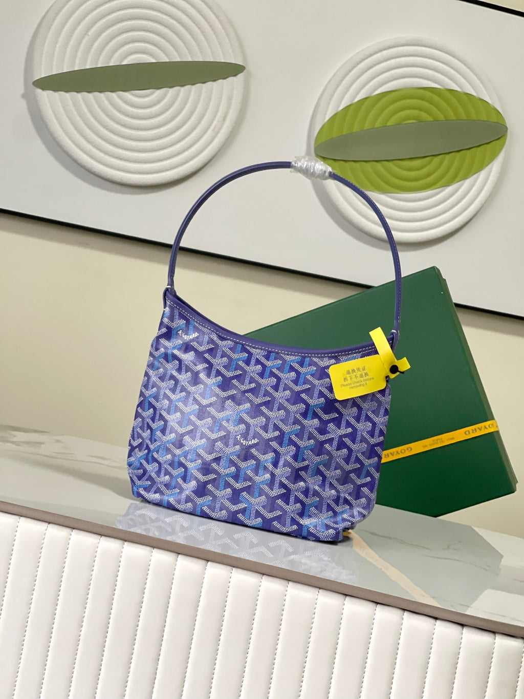 Goyard blue monogram hobo bag with yellow logo tab and rounded handle