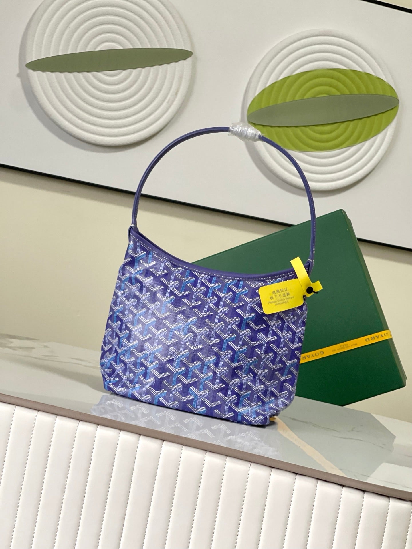 Goyard blue monogram hobo bag with yellow logo tab and rounded handle