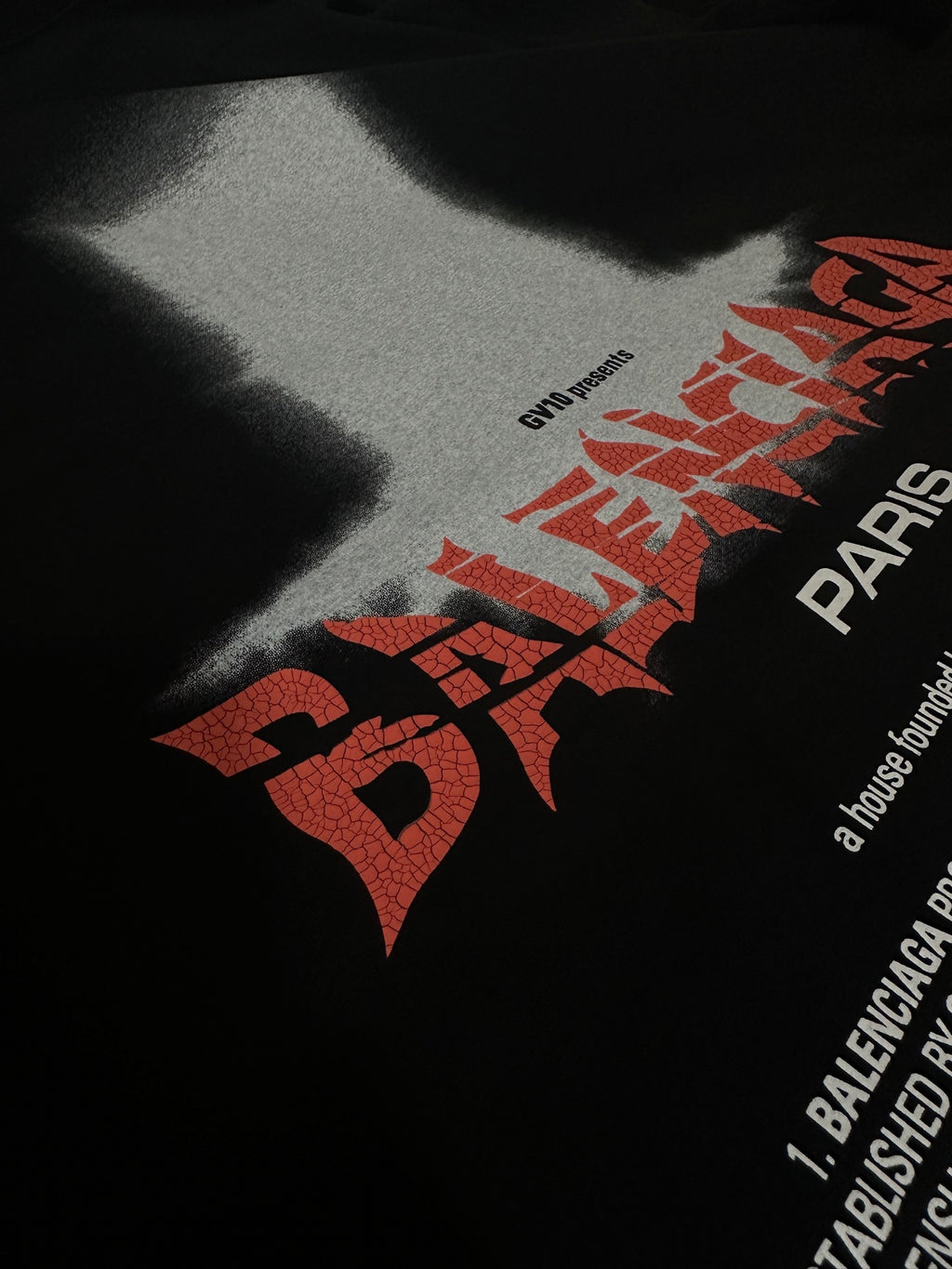Black T-shirt close-up of red and white graphic logo text