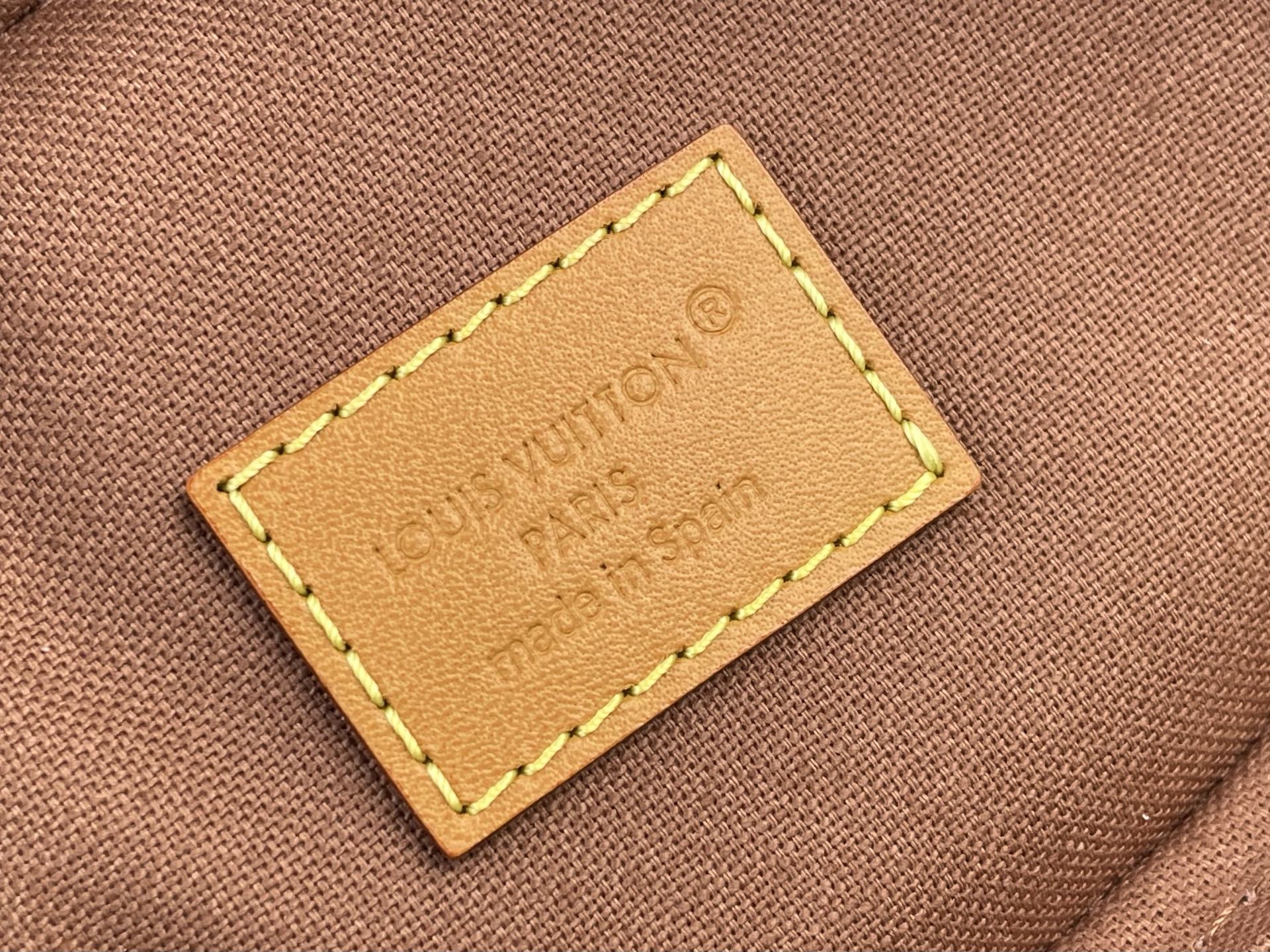 Louis Vuitton bag leather logo patch with yellow edge stitching on brown canvas