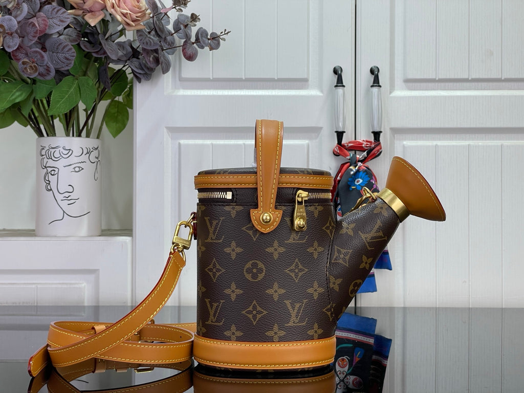 Louis Vuitton monogram bucket bag with tan leather straps and gold-tone hardware