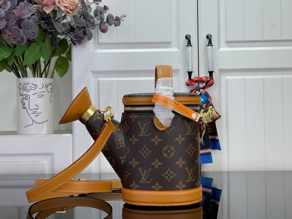 Louis Vuitton monogram bucket bag with top opening, tan handles, and gold-tone trim