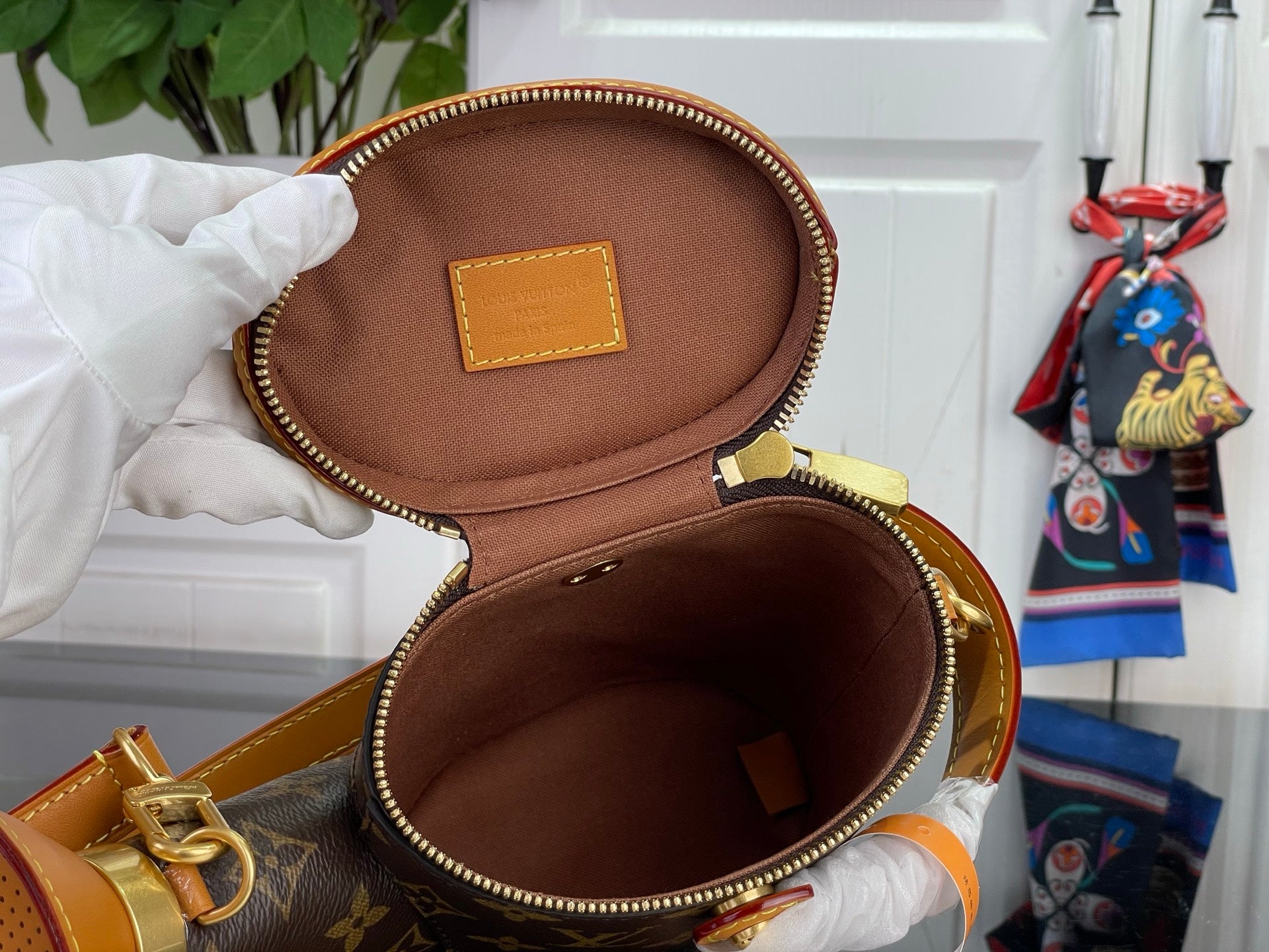 Louis Vuitton bag open with brown interior lining and front leather label