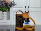 Louis Vuitton monogram bucket bag with round tan handle, crossbody strap, gold accents