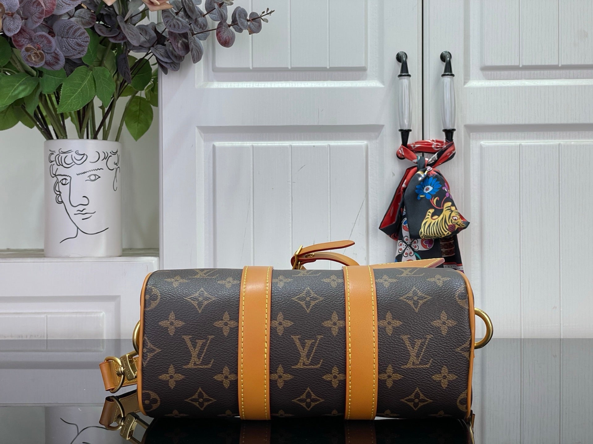 Monogram canvas duffel bag with tan center stripe and end handles