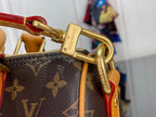 Gold-tone clasp hardware on monogram canvas duffel with tan leather trim