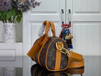 Monogram canvas duffel bag with tan leather shoulder strap and side handle
