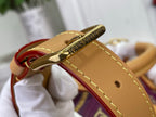 Louis Vuitton purple monogram handbag close-up of gold-tone keyring and tan strap