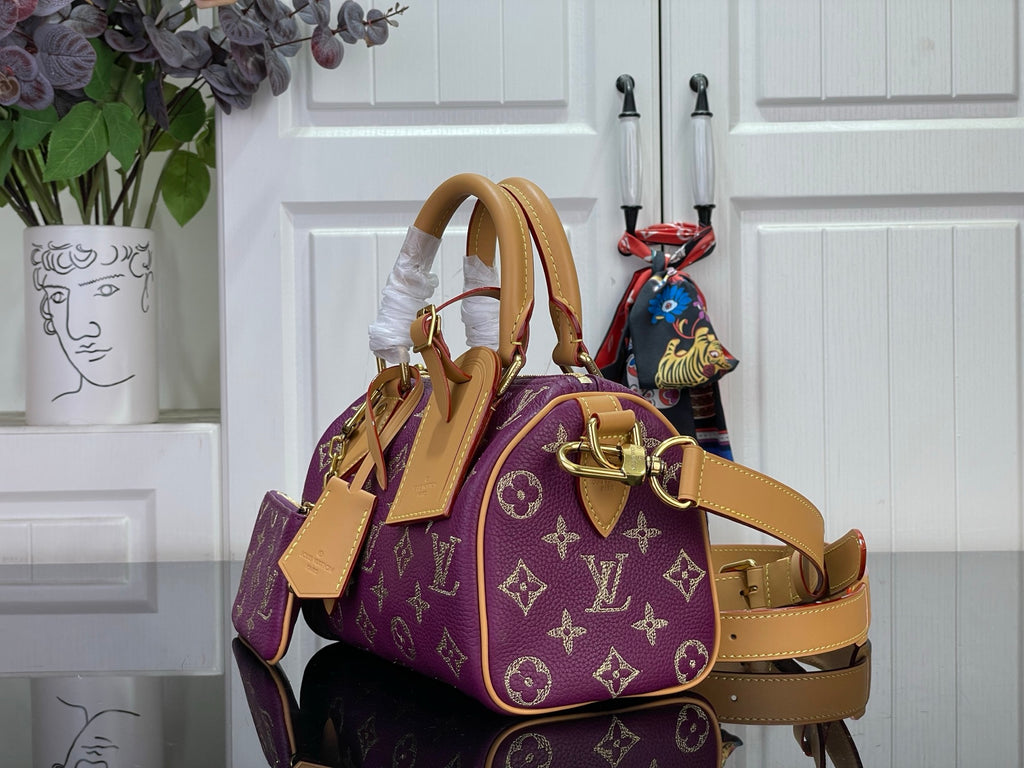 Louis Vuitton purple monogram handbag with tan leather handles and wide shoulder strap