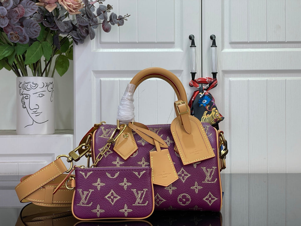Louis Vuitton purple monogram handbag with tan leather handles and crossbody strap