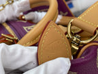 Louis Vuitton purple monogram handbag close-up of tan handle base with embossed logo