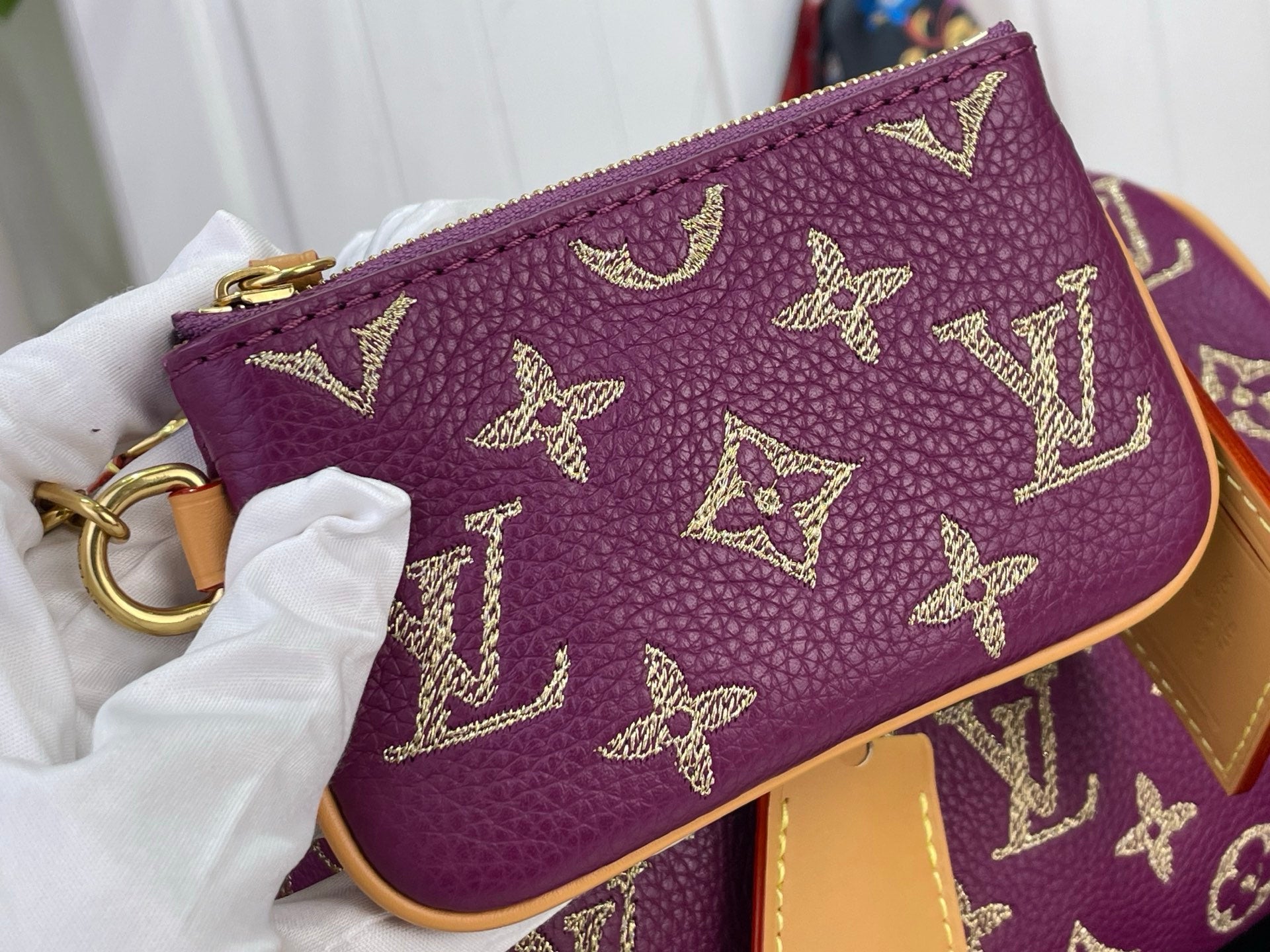 Louis Vuitton monogram mini bag, purple leather with gold pattern and tan trim