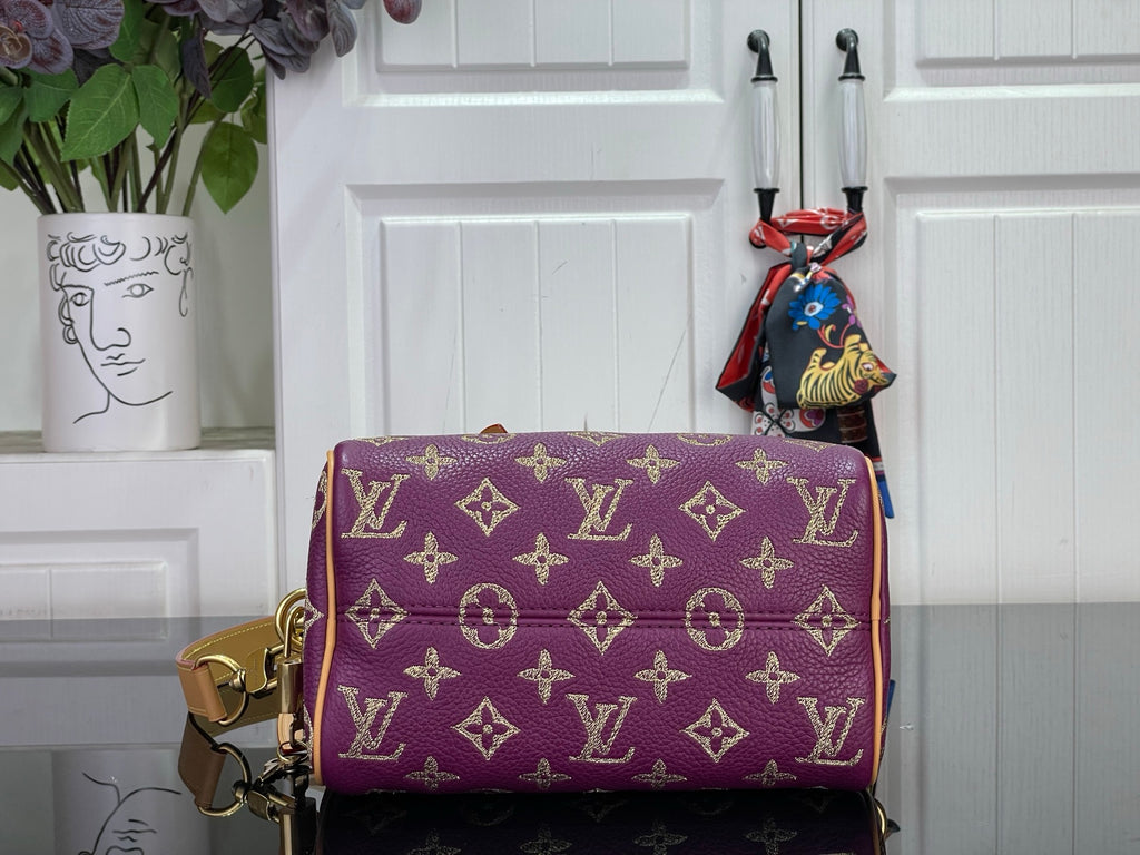 Louis Vuitton purple monogram handbag with tan trim and gold-tone side hardware