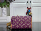 Louis Vuitton purple monogram handbag with tan trim and gold-tone side hardware
