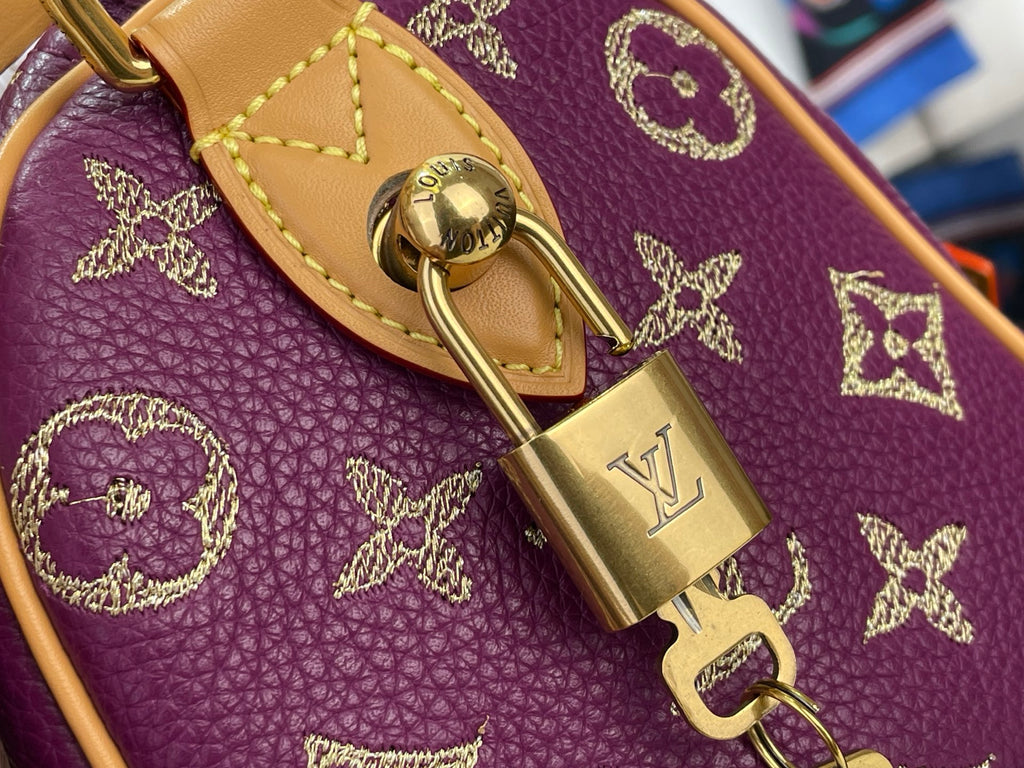Louis Vuitton monogram bag, purple leather with gold buckle and padlock