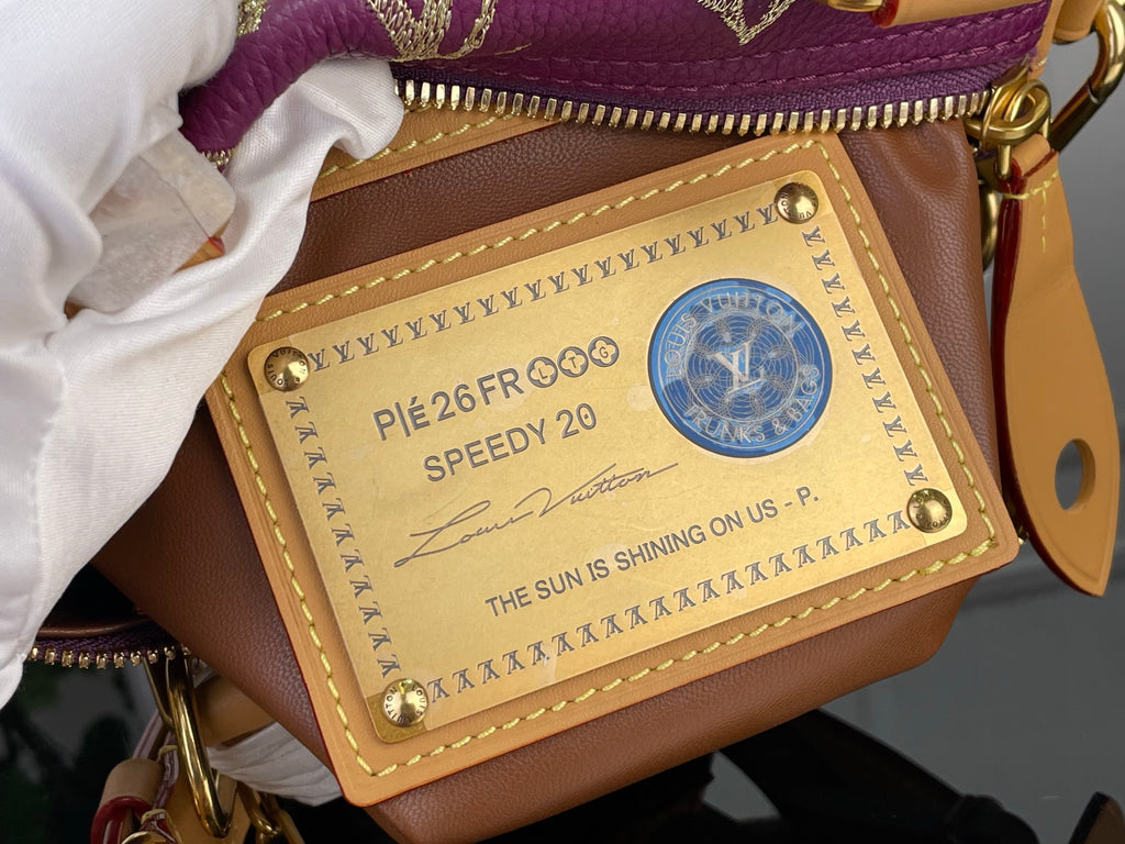 Louis Vuitton Speedy 20 label on brown pocket inside purple monogram bag