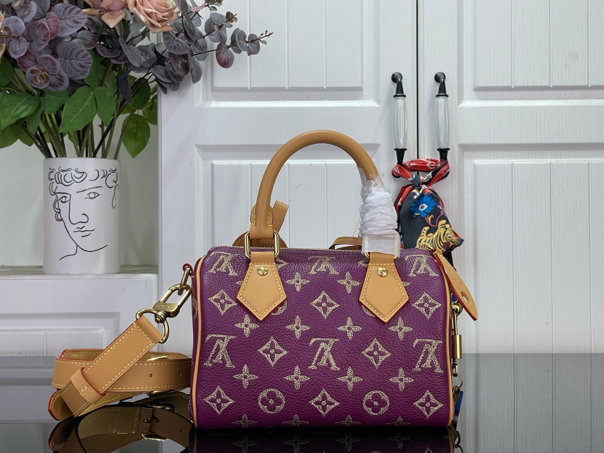 Louis Vuitton purple monogram handbag with tan top handles and side strap
