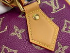 Louis Vuitton purple monogram handbag close-up of tan leather tab with gold rivet