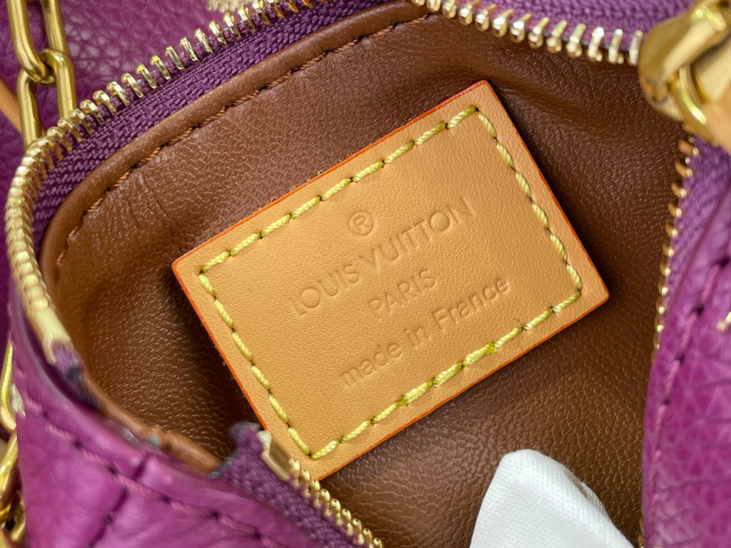 Louis Vuitton leather label patch inside purple monogram bag