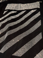 Black T-shirt close-up of sparkling rhinestone diagonal stripes