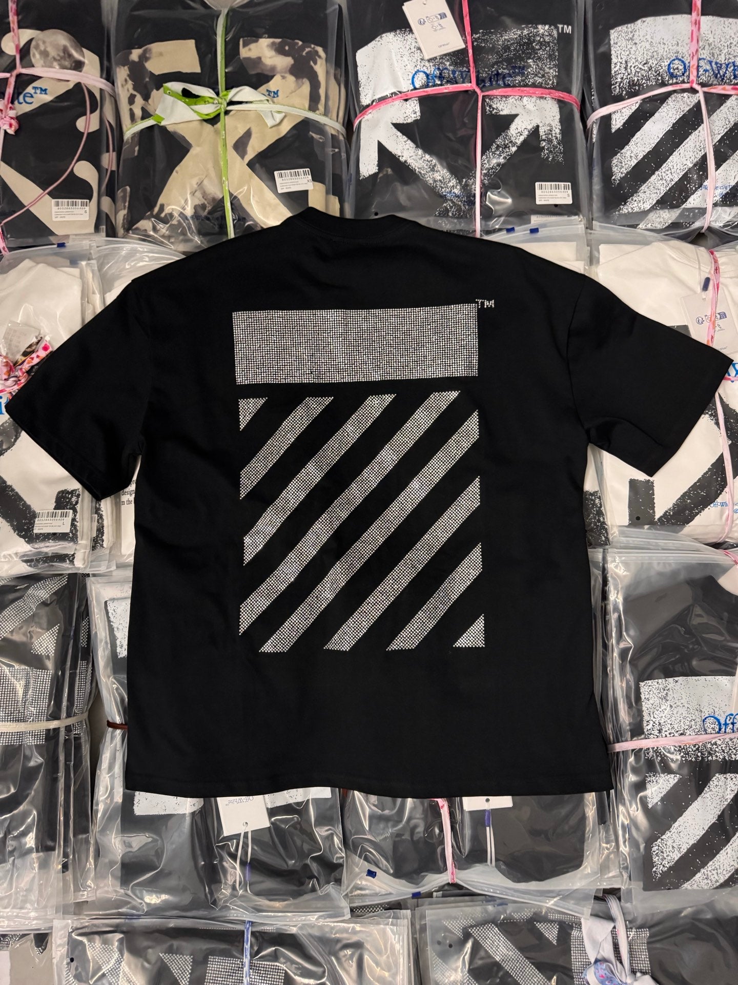 Black short-sleeve T-shirt with large rhinestone arrow stripe graphic on back