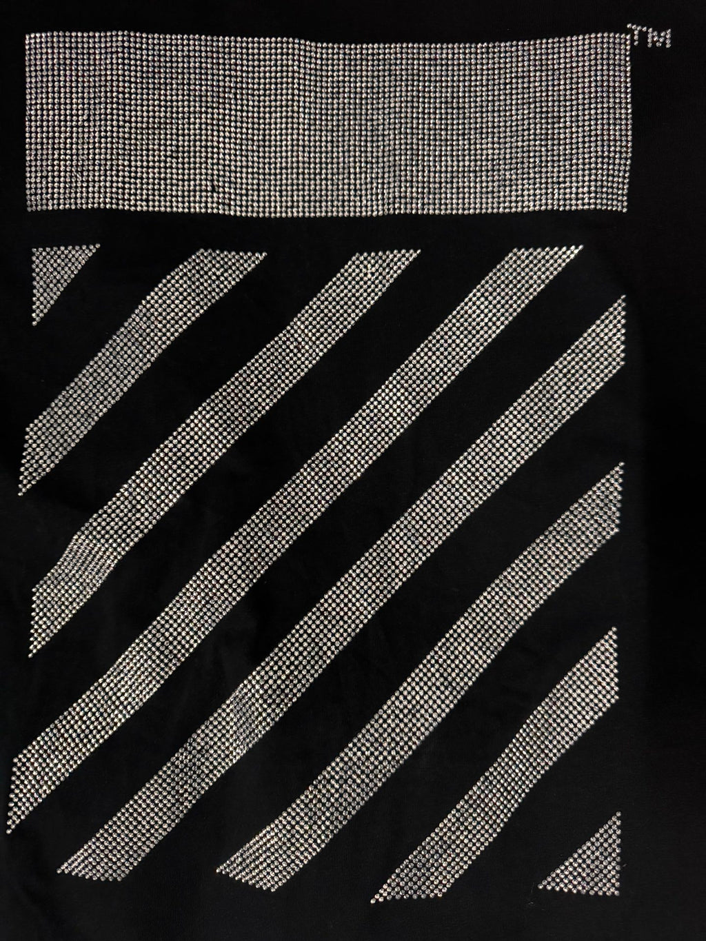 Black T-shirt close-up of rhinestone rectangle and diagonal stripe graphic